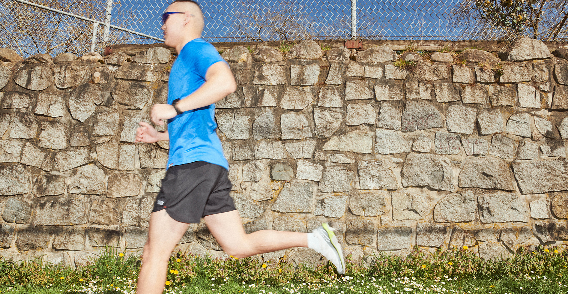 A person running outside wearing the Hightrail 2N1 5" Short and All Day Aerator Short Sleeve Crew.