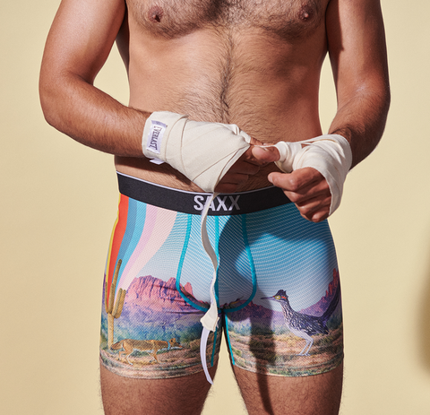 A person unwrapping their hands for boxing while wearing the Volt Boxer Brief in Desert Daze.